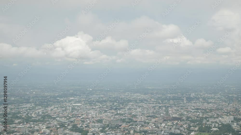 aerial view above the local city of chiangmai town from mountain hill under the cloud and fog level in daytime aerial view above the local city of chiangmai town from mountain hill under the cloud and fog level in daytime