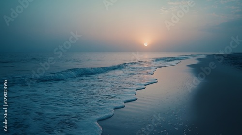 Gentle Sunrise Breaking Over Calm Beach with Ocean Waves