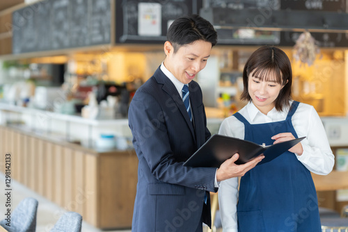 Foto カフェ店員と商談をするビジネスマン