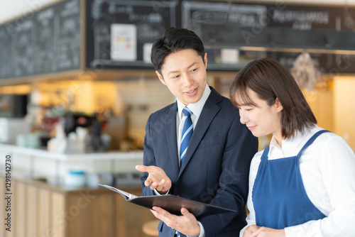 Foto カフェ店員と商談をするビジネスマン