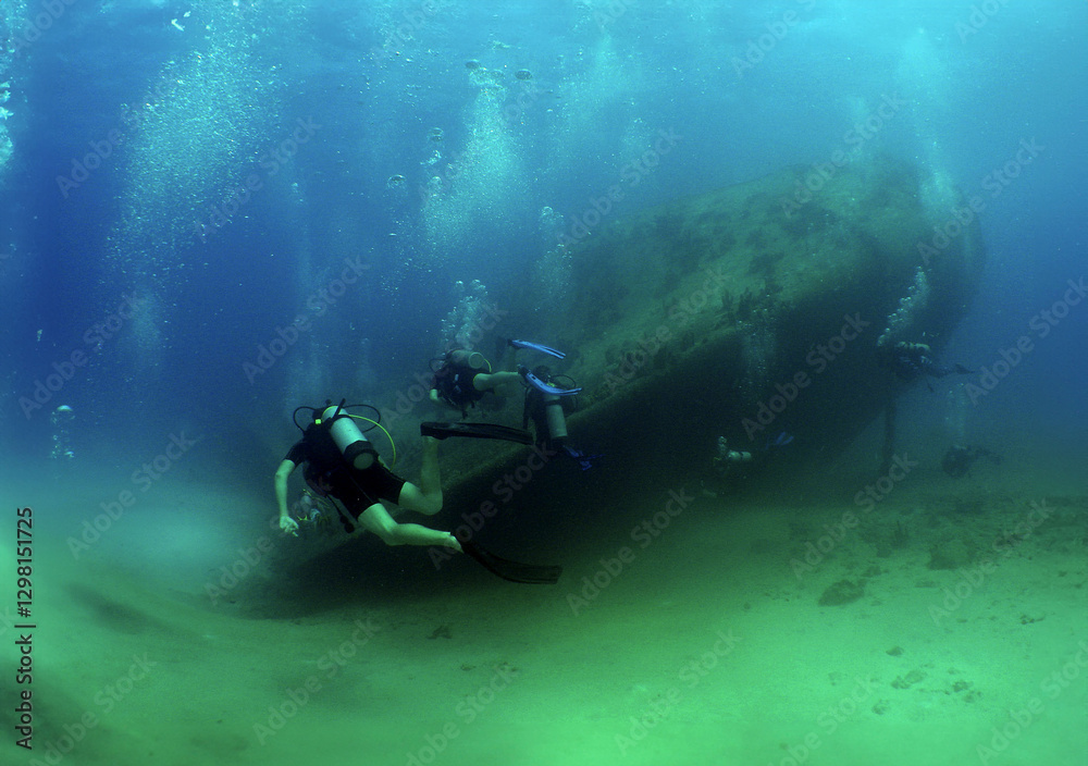 a diver exploring a sunken ship off the coast of Aruba a diver exploring a sunken ship off the coast of Aruba