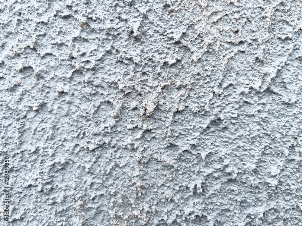 Naklejka premium Rough texture of a concrete wall with cracks and irregularities. Gray tones, ideal for urban projects, backgrounds or industrial design. High quality, detail