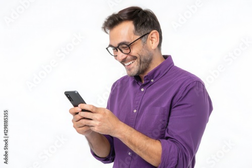 Smiling Young Man in Purple Shirt Engaged with Smartphone Against a White Background