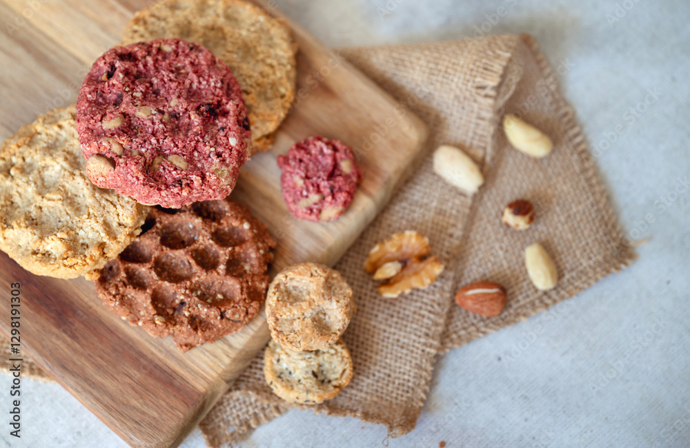 Fototapeta premium Oat cookies with nuts and seeds on shadows background