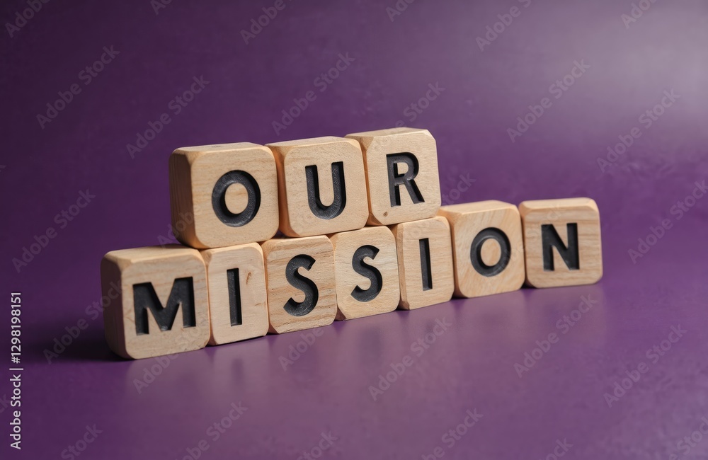 Obraz premium Our Mission message written on wooden blocks with purple background. Business concept of company statement, corporate aim, core value, guiding principle, long-term strategy.