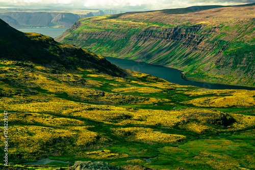 Vibrant green valley surrounded by steep cliffs and river