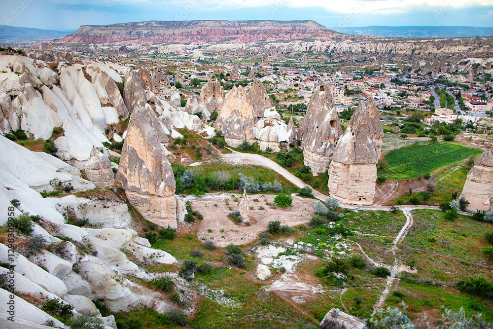 Majestic rock formations rise above the enchanting landscape of Cappadocia at sunset.