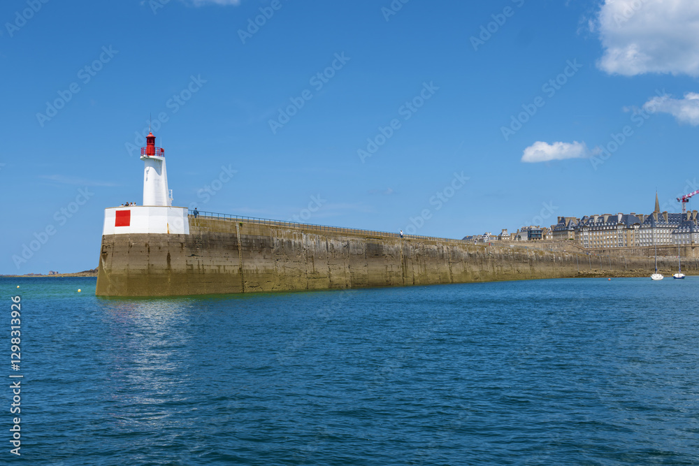 lighthouse at the entrance to the harbor and bulwark and patrician houses of Saint Malo, Brittany, France lighthouse at the entrance to the harbor and bulwark and patrician houses of Saint Malo, Brittany, France