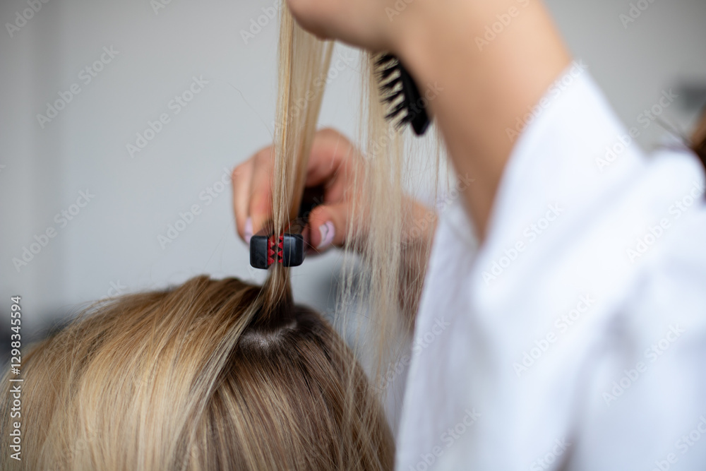 Naklejka premium women hairdresser styles models blonde hair by corrugating them with black and red corrugater