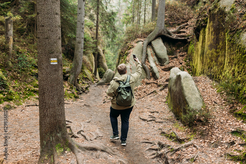 No communication coverage, lost contact signal device. Sad blonde man got lost and could not find an internet connection on phone while hiking alone in the wild forest. Adventure and tourism concept