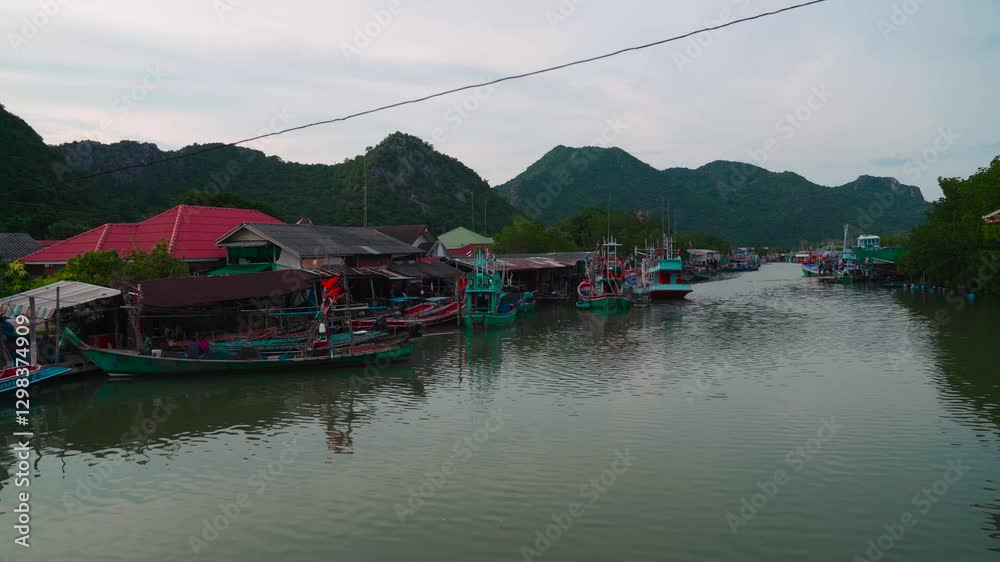 Traditional fishing boats anchored at the river near Bang Pu, Khao Sam Roi Yot,Thailand, with lush hills. Traditional fishing boats anchored at the river near Bang Pu, Khao Sam Roi Yot,Thailand, with lush hills.