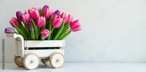 White wooden cart with pink and violet tulip bunches, violet, whitish