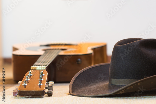 brown cowboy hat and acoustic guitar - country music and line dance - text space on top