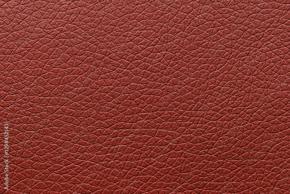 Burgundy color pebbled leather texture pattern as background Burgundy color pebbled leather texture pattern as background