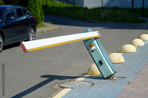 Obraz na płótnie Damaged automatic parking barrier, tilted barrier with torn out fastenings from the sidewalk. Broken parking barrier indicating an accident. Traffic accident. w salonie