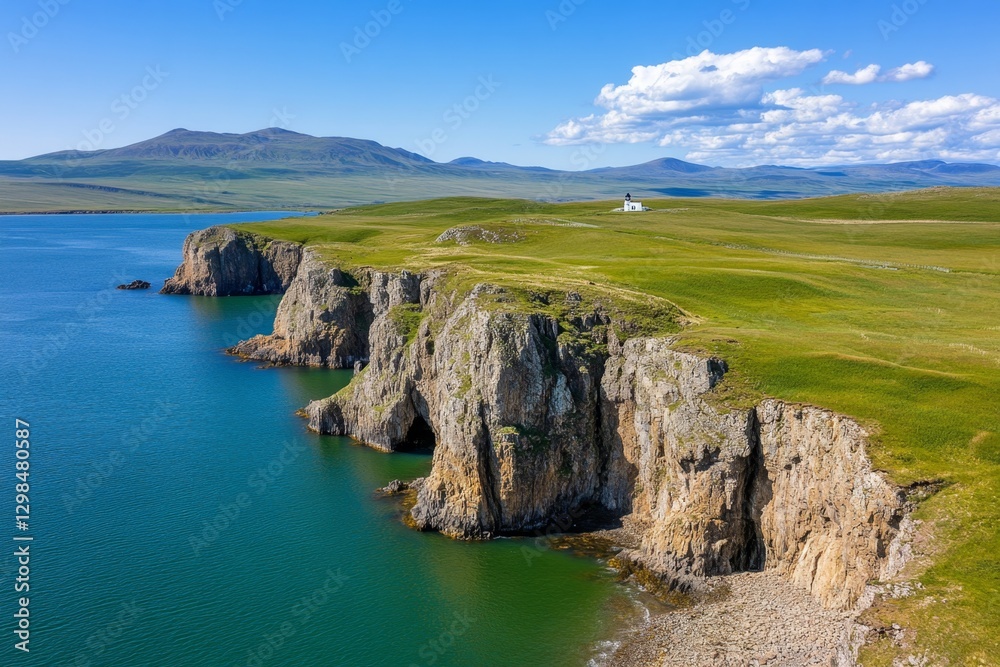 Fototapeta premium A breathtaking aerial view of cliffs meeting the ocean, with a lighthouse perched at the edge