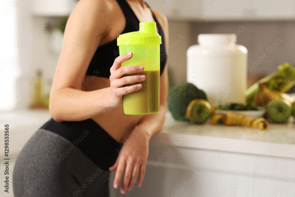 Weight loss. Woman with shaker of protein in kitchen, closeup Weight loss. Woman with shaker of protein in kitchen, closeup
