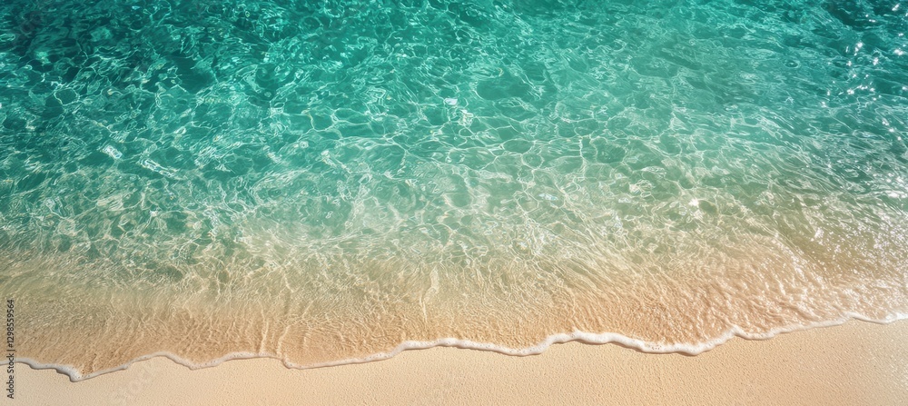 Naklejka premium Aerial view of tranquil aqua waters blending into sandy shoreline