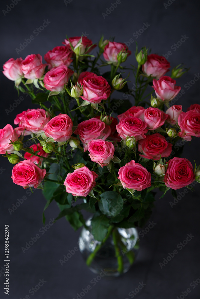Beautiful bouquet of pink (red) roses bushes on a black background. Selective focus, close-up. Beautiful bouquet of pink (red) roses bushes on a black background. Selective focus, close-up.