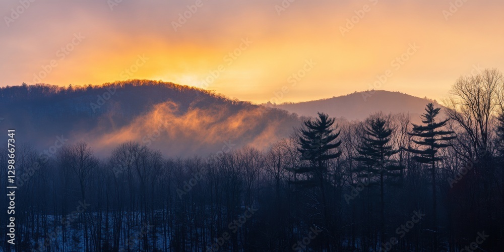 Obraz premium Morning mist rises over rolling hills under a vibrant sunrise in a tranquil forest landscape