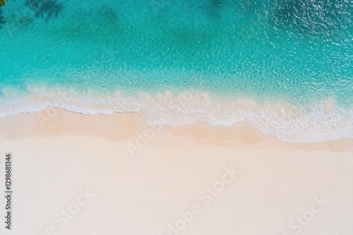 Aerial view of serene beach with turquoise waters meeting soft s