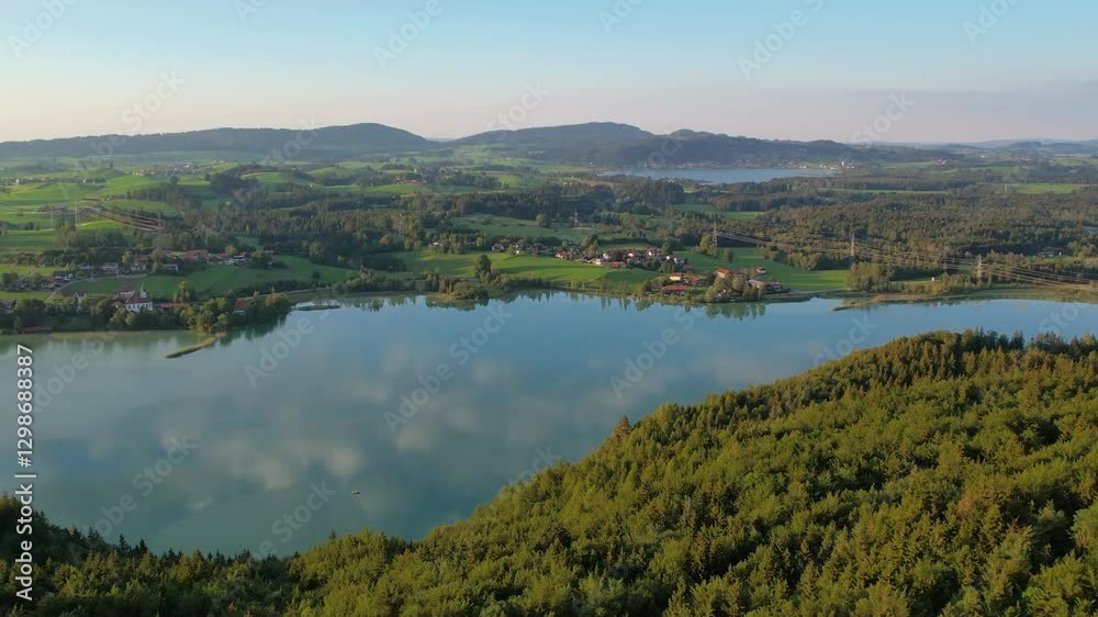 Sunset fly over mountain countryside and lake Weissensee, Germany. Wild nature and pine forest. Natural reserve Sunset fly over mountain countryside and lake Weissensee, Germany. Wild nature and pine forest. Natural reserve