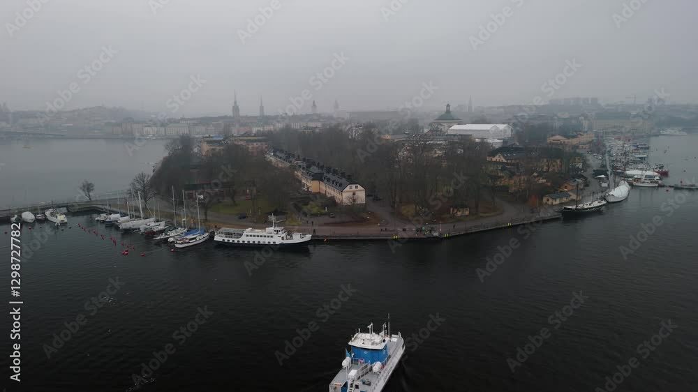 Aerial shot of a transportation boat going towards a small island