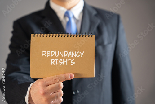 Redundancy rights concept. Legal protections and entitlements employees have when they are made redundant due to their job no longer being necessary. Businessman in suit holding notebook