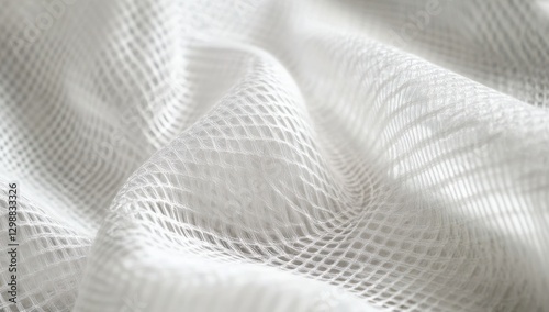 White mesh fabric with subtle texture and soft folds, showcasing intricate patterns and light reflections for artistic or fashion design applications