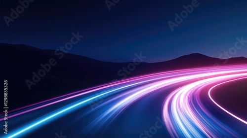 aerial view of scenic mountain highway at night glowing with smooth light trails from fast-moving vehicles