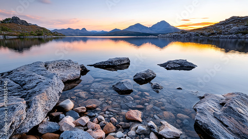 serene mountain lake reflecting vibrant twilight colors and rocky shoreline