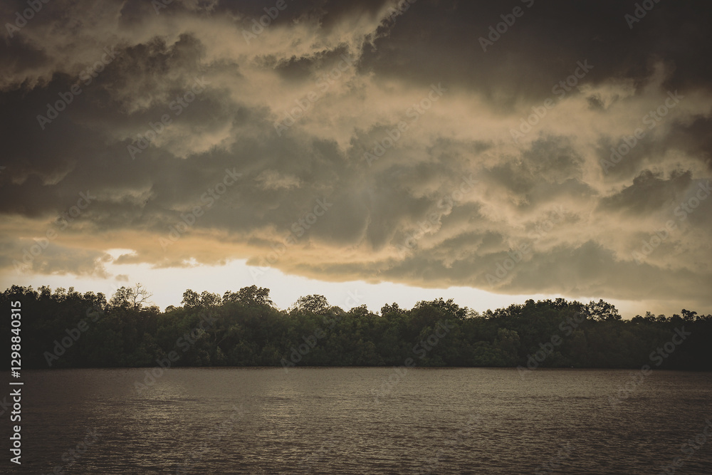Storm Brewing- thick dark clouds shot during sunset time over the Kuala Selangor river Storm Brewing- thick dark clouds shot during sunset time over the Kuala Selangor river