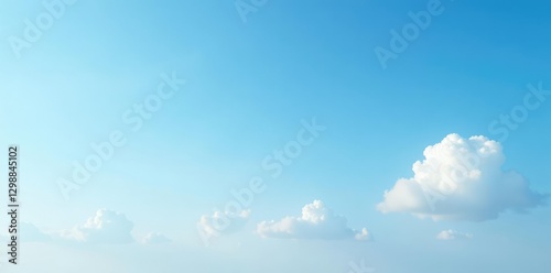 Soft blue sky with few white clouds drifting lazily, peaceful, atmosphere, serene