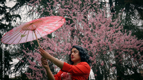 Obraz na płótnie Model posing with pink parasol in front of blooming cherry trees w salonie