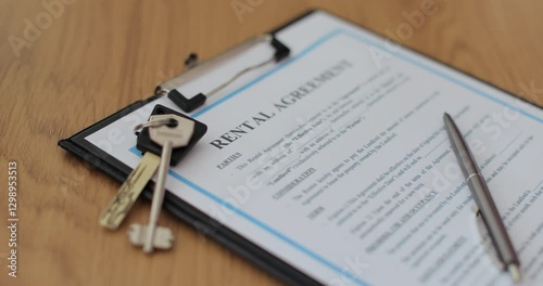 Close-up view of a rental agreement document with key, and a pen placed on top. Property rental, leasing contracts, real estate.