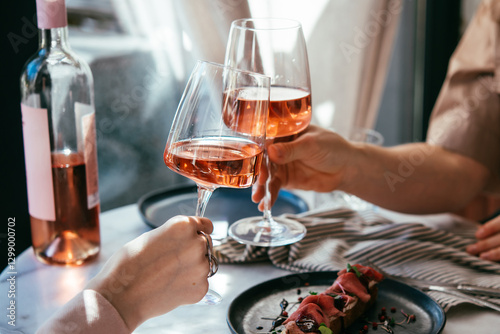 Glasses of rose wine seen during a friendly party or a celebration in a restaurant of a bar.