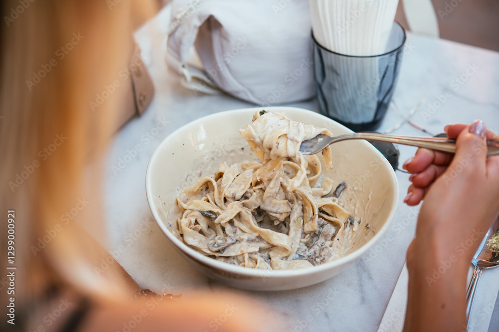 Having a pasta dinner at home or in a restaurant.