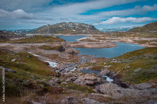 Nature in Norway. A breathtakingly beautiful landscape with a mountain river featuring islets and mountains in the background. A quiet, deserted place.