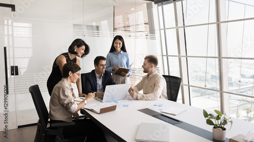 Effective project management. Creative multicultural group of diverse age businesspeople teammates coworkers lead by mature male ceo boss collaborate on startup develop new solution using notebook pc