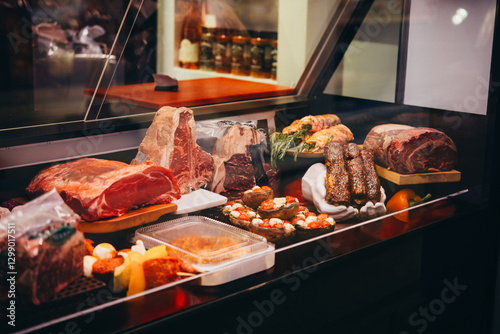 Obraz na płótnie Different kinds of meat and sausages on sale at a local market or butchery. w salonie