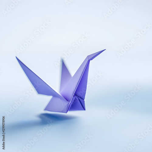 Lavender origami crane in flight against a light blue background;  symbol of hope and peace; for design or spiritual projects