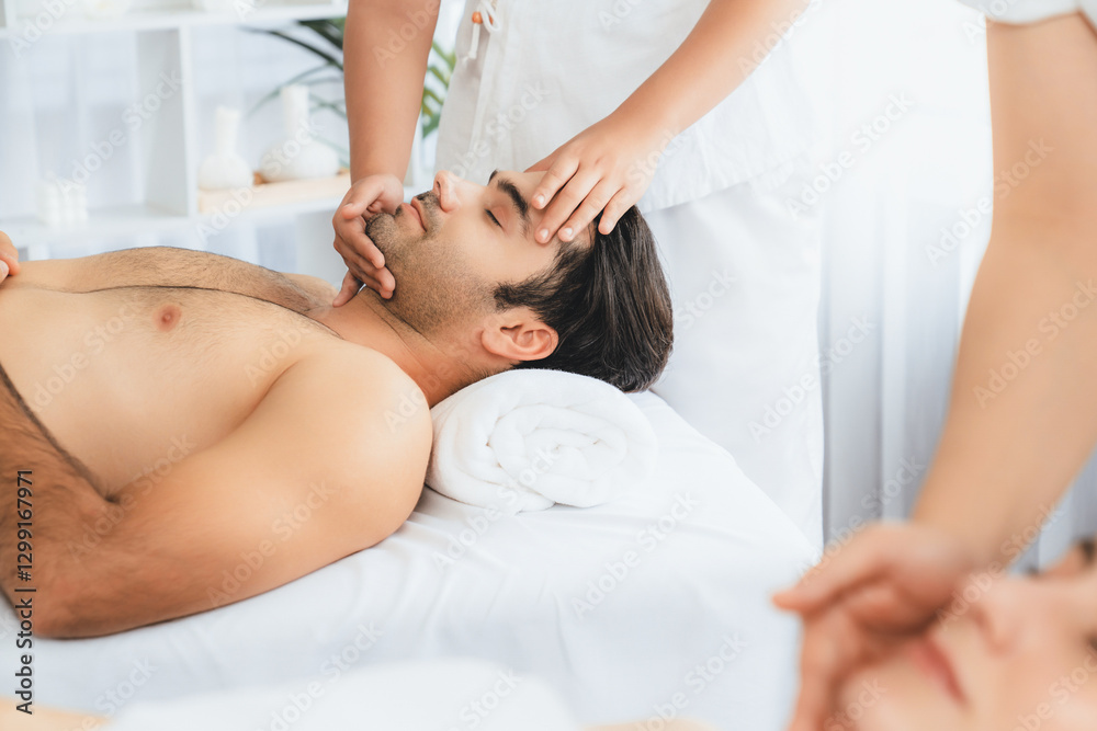 Caucasian couple enjoying relaxing anti-stress head massage and pampering facial beauty skin recreation leisure in dayspa modern light ambient at luxury resort or hotel spa salon. Quiescent Caucasian couple enjoying relaxing anti-stress head massage and pampering facial beauty skin recreation leisure in dayspa modern light ambient at luxury resort or hotel spa salon. Quiescent