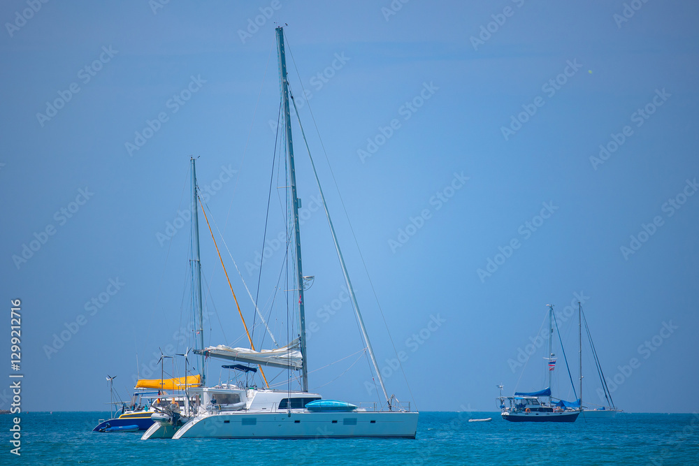 Sailboats anchored in tranquil thai waters Sailboats anchored in tranquil thai waters