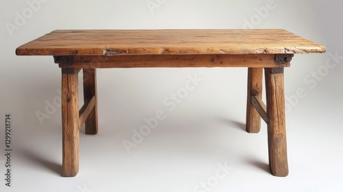 A rustic wooden dining table with a natural oak finish, featuring thick, sturdy legs.