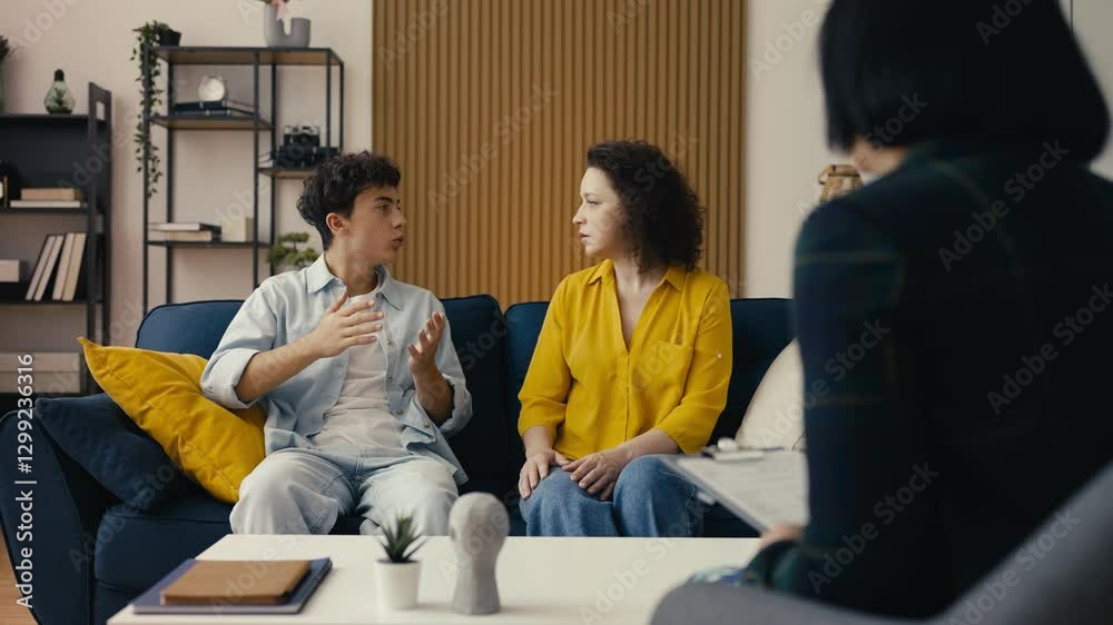 Teenage son arguing with his mom during a therapy session, family conflict