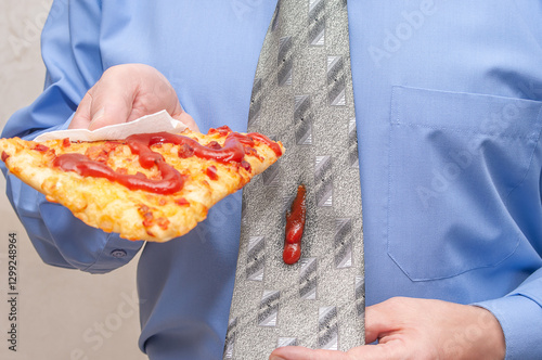 Wallpaper Mural A man is holding a slice of pizza in his hand and is letting some of the ketchup drip onto his tie. Torontodigital.ca