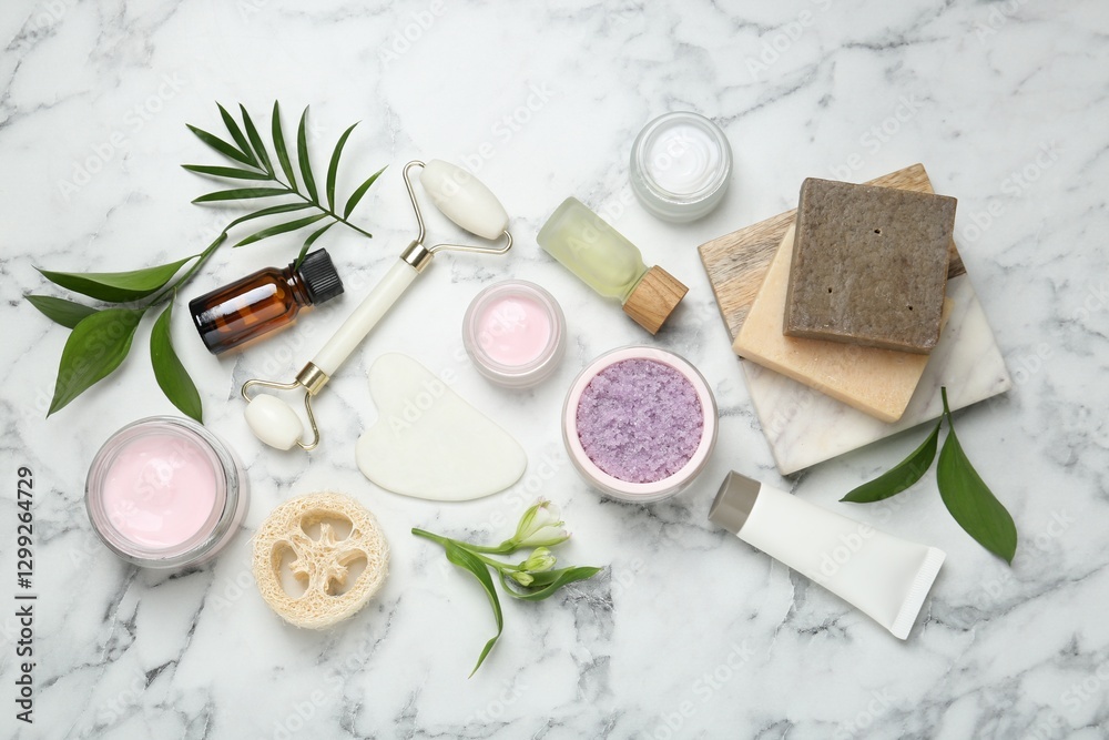 Flat lay composition with different body care products and flowers on white marble table Flat lay composition with different body care products and flowers on white marble table