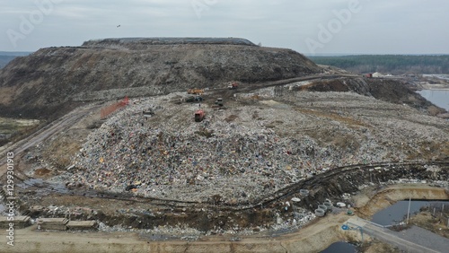 Work on unloading, systematising, debunking waste at the city's huge municipal waste collection landfill. Graders and bulldozers clear the heaps of rubbish unloaded from rubbish trucks.