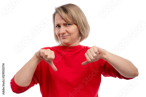 A woman in a red shirt making a thumbs-down gesture against a white background.