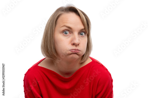 Fényképezés A woman with a surprised expression, puffing her cheeks while wearing a red sweater against a white background
